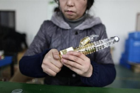 A worker checks a vibrator during a test process at Ningbo Yamei plastic toy factory, on the outskirts of Fenghua, Zhejiang province, February 13, 2012.