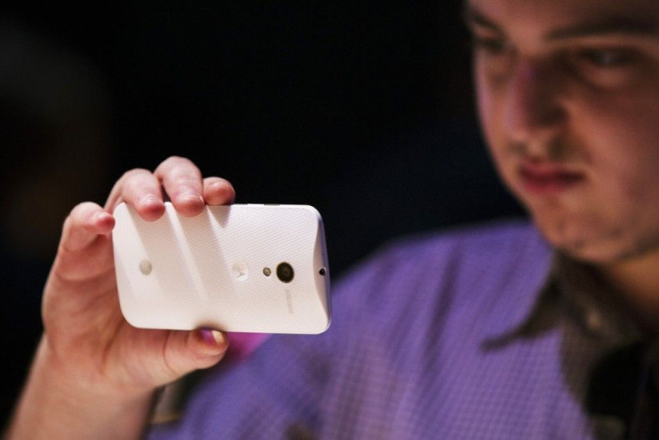 A member of the media examines a Motorola phone