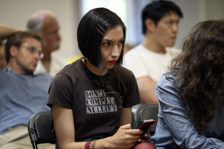  Melinda McCrady texts and watches a speaker