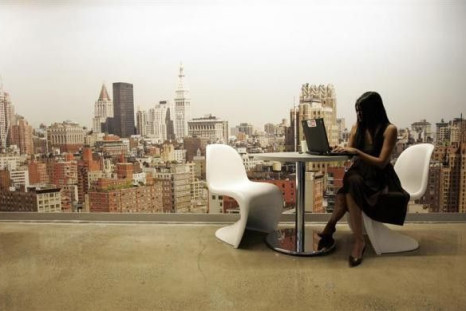 A Google Employee Works on a Laptop in Front of a Mural of the New York City Skyline, at the New York City Company