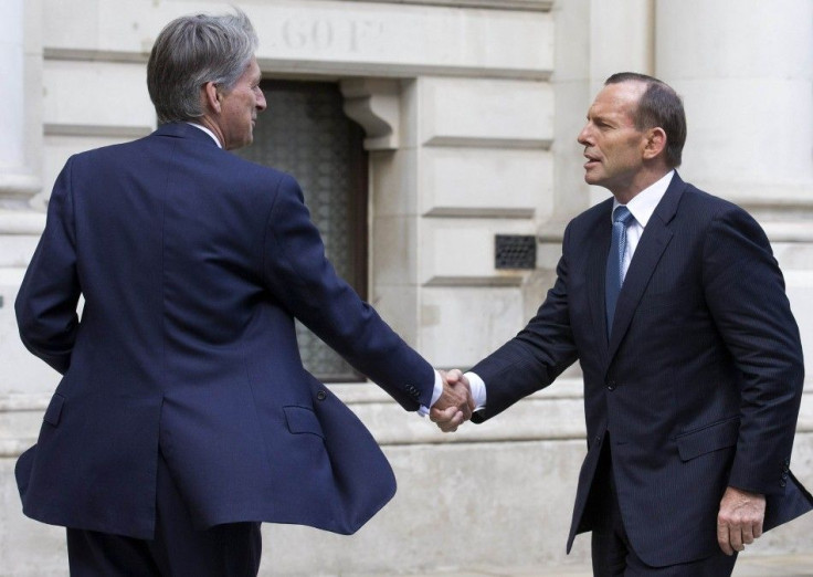 Britain's Foreign Secretary Philip Hammond greets Australia's Prime Minister Tony Abbott outside the Foreign and Commonwealth Office, in central London