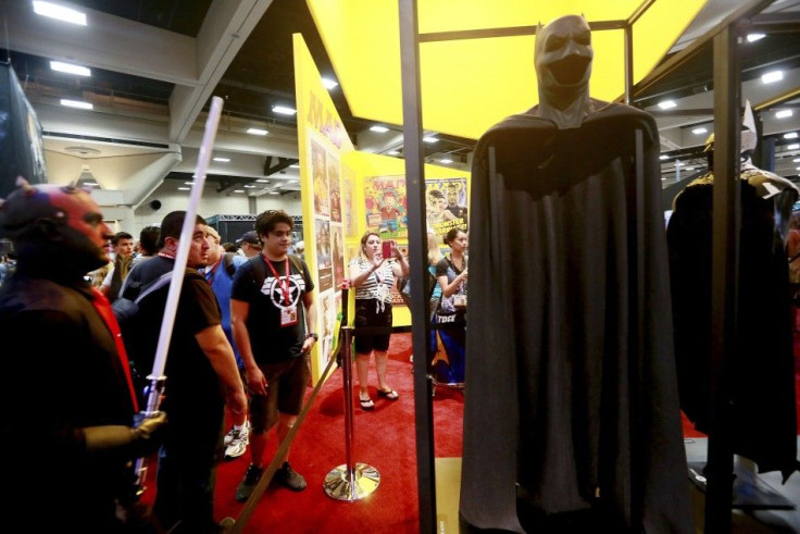 Attendees look over the new Batman outfit