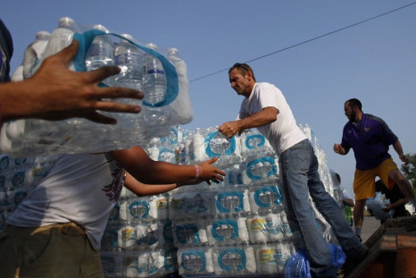 Volunteers unload drinking water from a truck outside Waite High School in Toledo