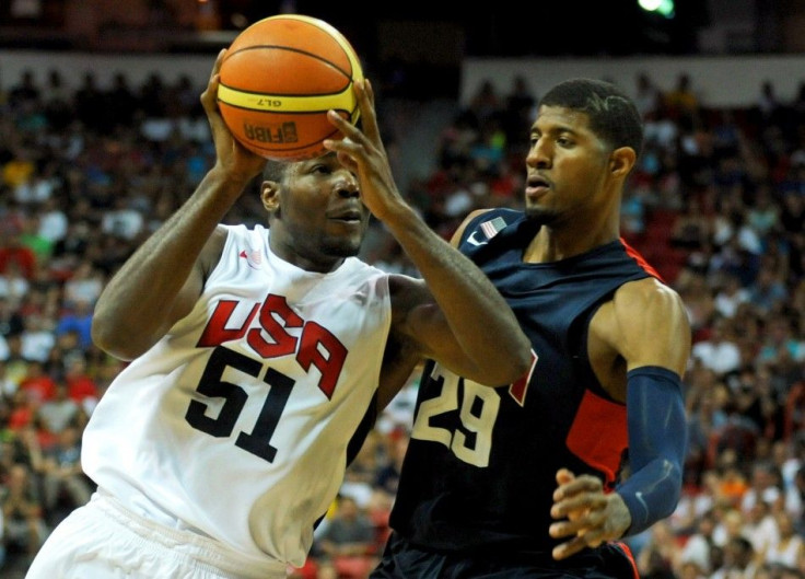 Aug 1, 2014; Las Vegas, NV, USA; USA Team White forward Paul Milsap (51) drives the ball against the defense of USA Team Blue guard Paul George (29) during the USA Basketball Showcase at Thomas & Mack Center.