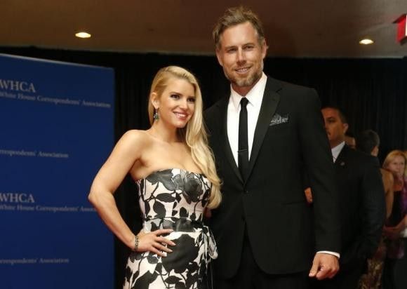 Actors Jessica Simpson and Eric Johnson arrive on the red carpet at the annual White House Correspondents Association Dinner in Washington, May 3, 2014.