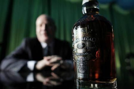 A bottle of Chivas Regal sits on a table in front of Darren Hosie, regional manager of Chivas Brothers, as he is interviewed by Reuters in Shanghai in this December 8, 2010 file photo.