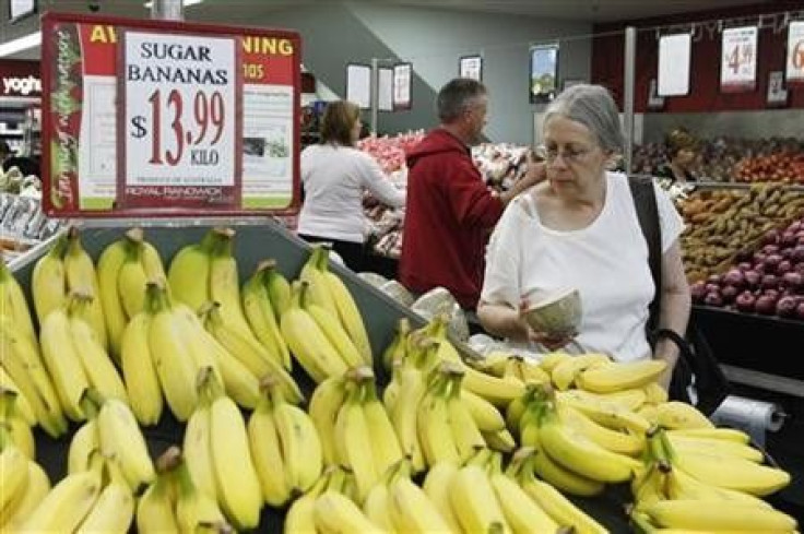 A customer looks at bananas in a supermarket in Sydney April 27, 2011