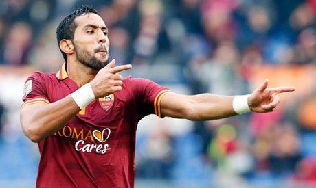 AS Romas Mehdi Benatia celebrates after scoring against Genoa during their Serie A soccer match at Olympic stadium in Rome, January 12, 2014