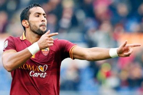 AS Roma's Mehdi Benatia celebrates after scoring against Genoa during their Serie A soccer match at Olympic stadium in Rome, January 12, 2014