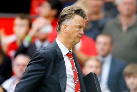 Manchester United's manager Louis van Gaal leaves the pitch following their English Premier League soccer match defeat against Swansea City at Old Trafford in Manchester, northern England August 16, 2014.