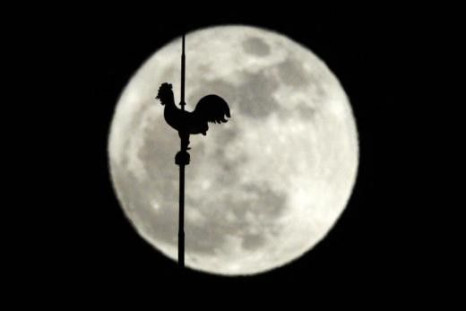 A weathervane is seen in front of the moon in Lausanne March 19, 2011.