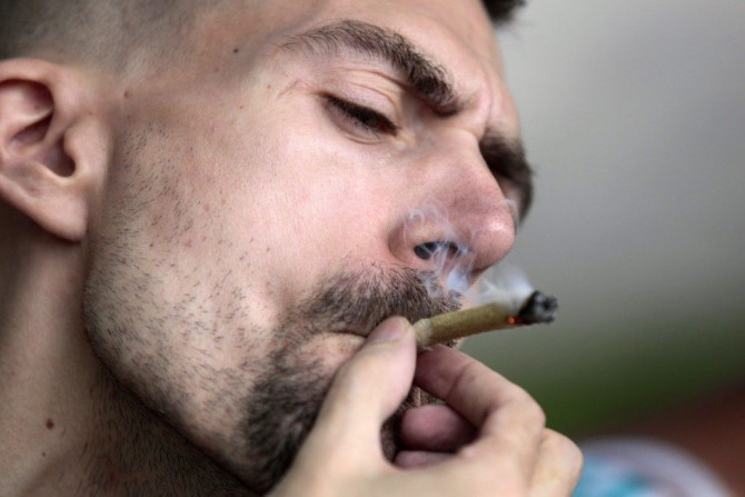 A man smokes marijuana during a gathering to welcome back marijuana advocate Marc Emery in Windsor, Ontario