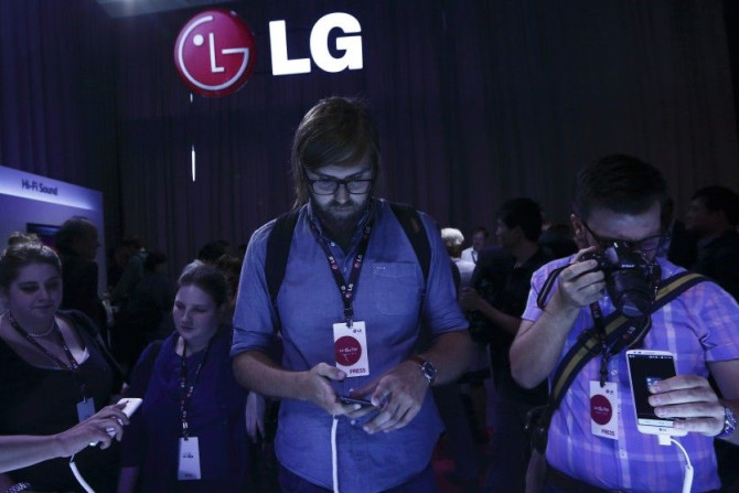 Journalists look at the new LG G2 smart phone