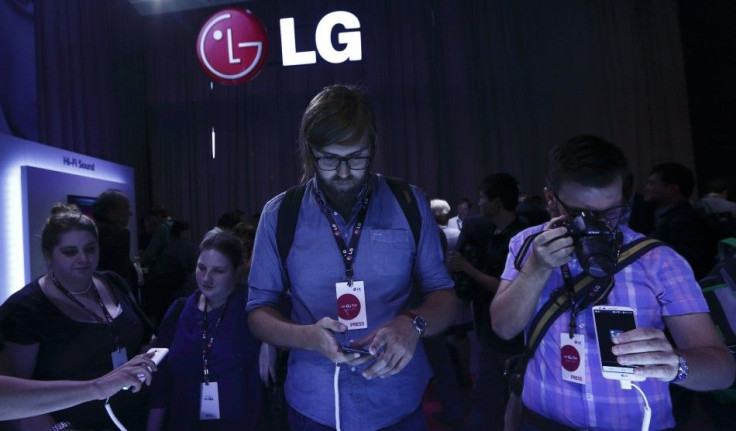Journalists look at the new LG G2 smart phone
