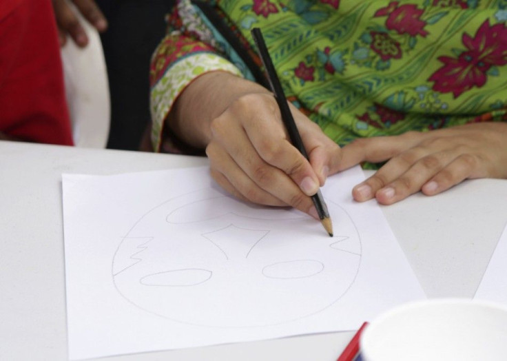 Pakistani schoolgirl activist Malala Yousafzai draws a face