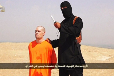 A Masked Islamic State Militant Holding A Knife Speaks Next To Man Purported To Be U.S. Journalist James Foley At An Unknown Location In This Still Image From An Undated Video Posted On A Social Media Website