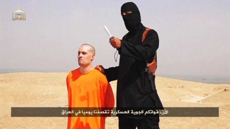 A Masked Islamic State Militant Holding A Knife Speaks Next To Man Purported To Be U.S. Journalist James Foley At An Unknown Location In This Still Image From An Undated Video Posted On A Social Media Website
