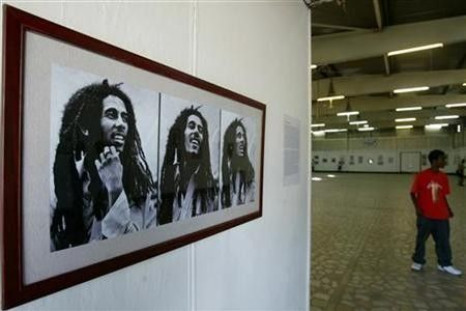 A reggae fan looks at photographs of Bob Marley