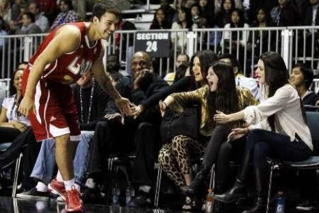 Television personality Rob Kardashian slaps hands with (from L-R) Los Angeles Lakers' Lamar Odom and sisters Khloe Kardashian, Kendall Jenner, and Kylie Jenner during the 2011 BBVA All-Star Celebrity basketball game.
