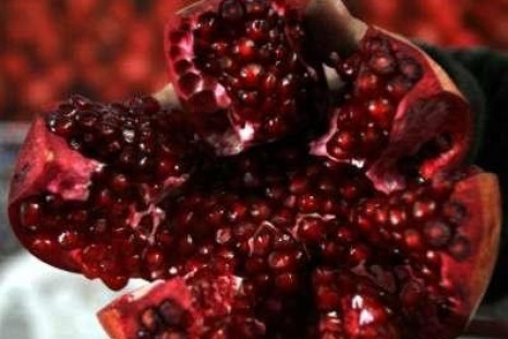 An Afghan seller displays produce for sale during the World Pomegranate Fair