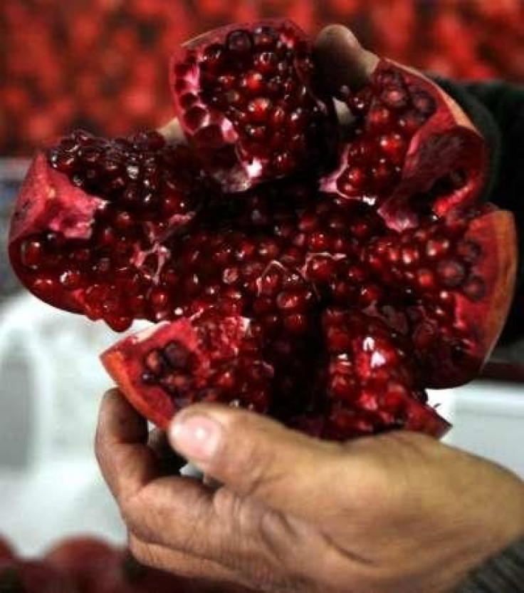 An Afghan seller displays produce for sale during the World Pomegranate Fair