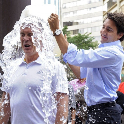 Liberal leader Justin Trudeau dumps a bucket of ice water onto Liberal MP Sean Casey for the ALS ice bucket challenge in Edmonton