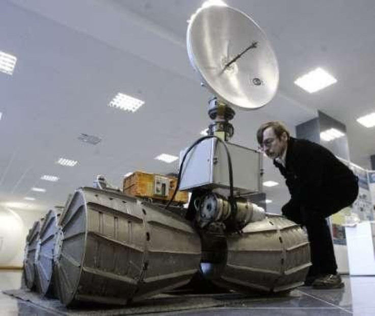 A man looks at a model of a Marsokhod mars rover in the exhibition hall of the Institute of Space Research