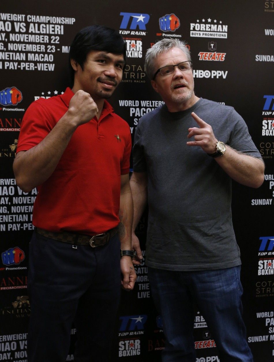Manny Pacquiao L from the Philippines and his trainer Freddie Roach pose during an interview at Venetian Macao in Macau