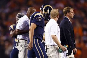 St. Louis Rams quarterback Sam Bradford is helped off the field after getting injury