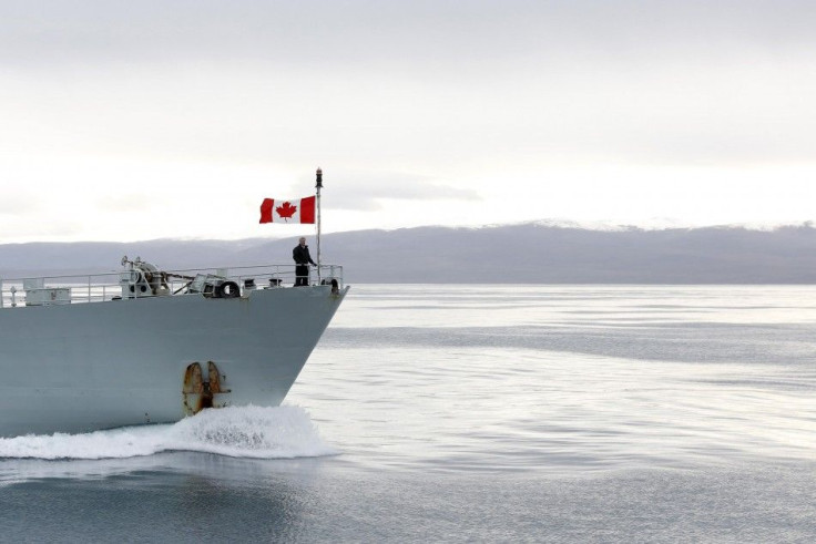 Canada's PM Harper stands on the front deck of the HMCS Kingston on Eclipse Sound near the Arctic community of Pond Inlet