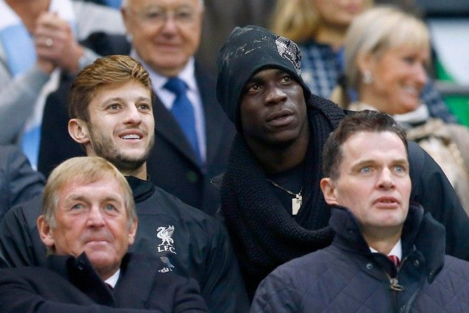 Liverpool's new signings Mario Balotelli (2nd R) and Adam Lallana (2nd L) watch their team during their English Premier League soccer match against Manchester City at the Etihad stadium in Manchester, northern England August 25, 2014.