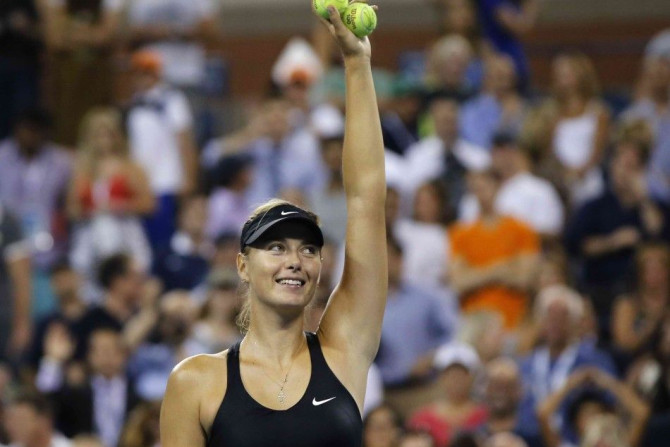 Maria Sharapova of Russia waves to the crowd after beating compatriot Maria Kirilenko during their match at the 2014 U.S. Open tennis tournament in New York, August 25, 2014. REUTERS/Shannon Stapleton