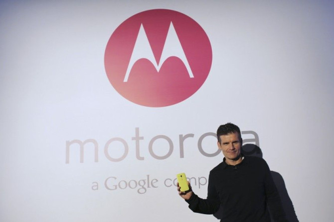Motorola Mobility Chief Executive Dennis Woodside Poses With The New Moto G Mobile Phone