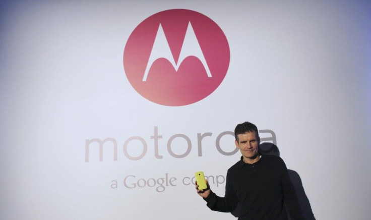 Motorola Mobility Chief Executive Dennis Woodside Poses With The New Moto G Mobile Phone