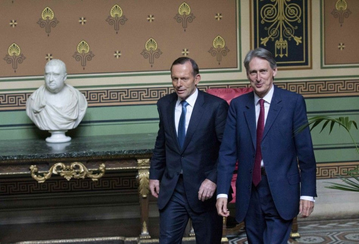 Britain's Foreign Secretary Philip Hammond walks with Australia's Prime Minister Tony Abbott in the Foreign and Commonwealth Office, in central London