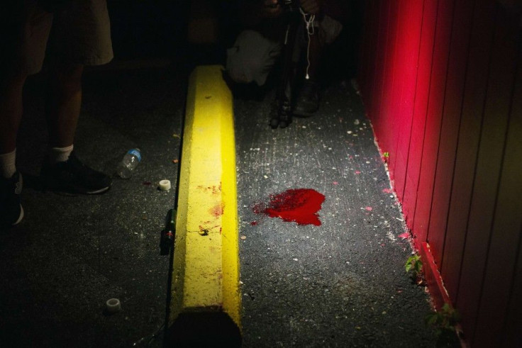 A blood pool from what witnesses said was a man who may have accidentally shot himself, is seen on the ground following a peaceful demonstration reacting to the shooting of Michael Brown in Ferguson