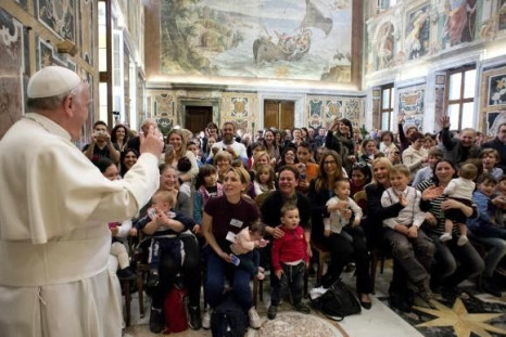Pope Francis waves the Children