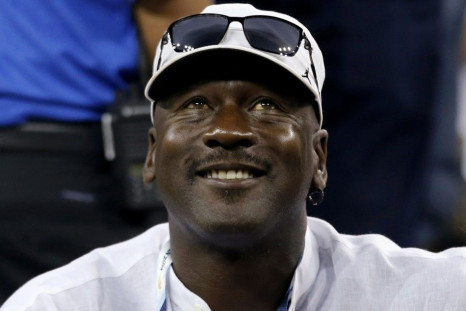 Former basketball great Michael Jordan watches Roger Federer