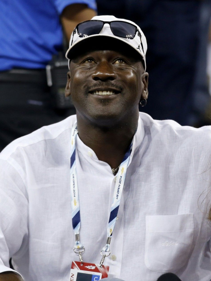 Former basketball great Michael Jordan watches Roger Federer