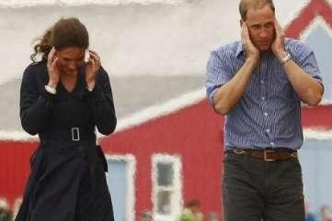 Britain&#039;s Prince William and Catherine, the Duchess of Cambridge, cover up their ears from the engine blast