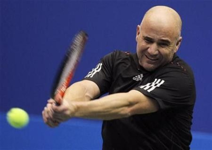 Andre Agassi of the U.S. returns a ball during an exhibition match against Gustavo Kuerten of Brazil in Rio de Janeiro, December 11, 2010.