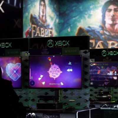 Visitors Play Video Games On Xbox At The Microsoft Exhibition Stand During The Gamescom 2014 Fair In Cologne