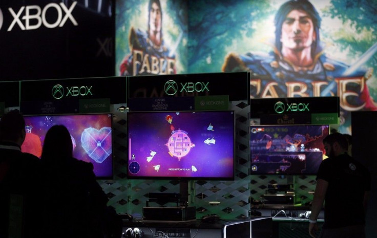 Visitors Play Video Games On Xbox At The Microsoft Exhibition Stand During The Gamescom 2014 Fair In Cologne