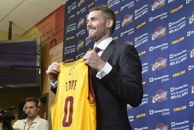Aug 26, 2014; Independence, OH, USA; Cleveland Cavaliers player Kevin Love poses with his jersey at Cleveland Clinic Courts.