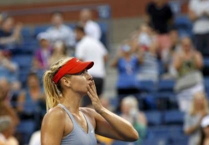 Maria Sharapova of Russia blows a kiss to the crowd after defeating Alexandra Dulgheru of Romania during their match at the 2014 U.S. Open tennis tournament in New York, August 27, 2014. REUTERSEduardo Munoz