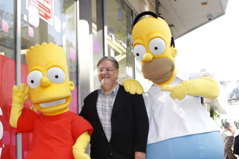 Matt Groening, creator of "The Simpsons," stands on his star with characters Homer (R) and Bart Simpson