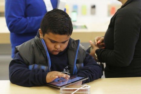 A Child Uses A iPad Air Tablet At The Apple Store.