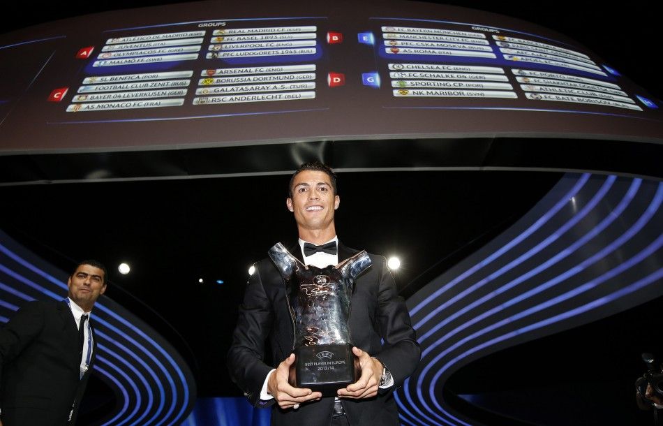 Real Madrids Cristiano Ronaldo displays his Best Player UEFA 2014 Award during the draw ceremony for the 20142015 Champions League soccer competition at Monacos Grimaldi Forum in Monte Carlo August 28, 2014. 