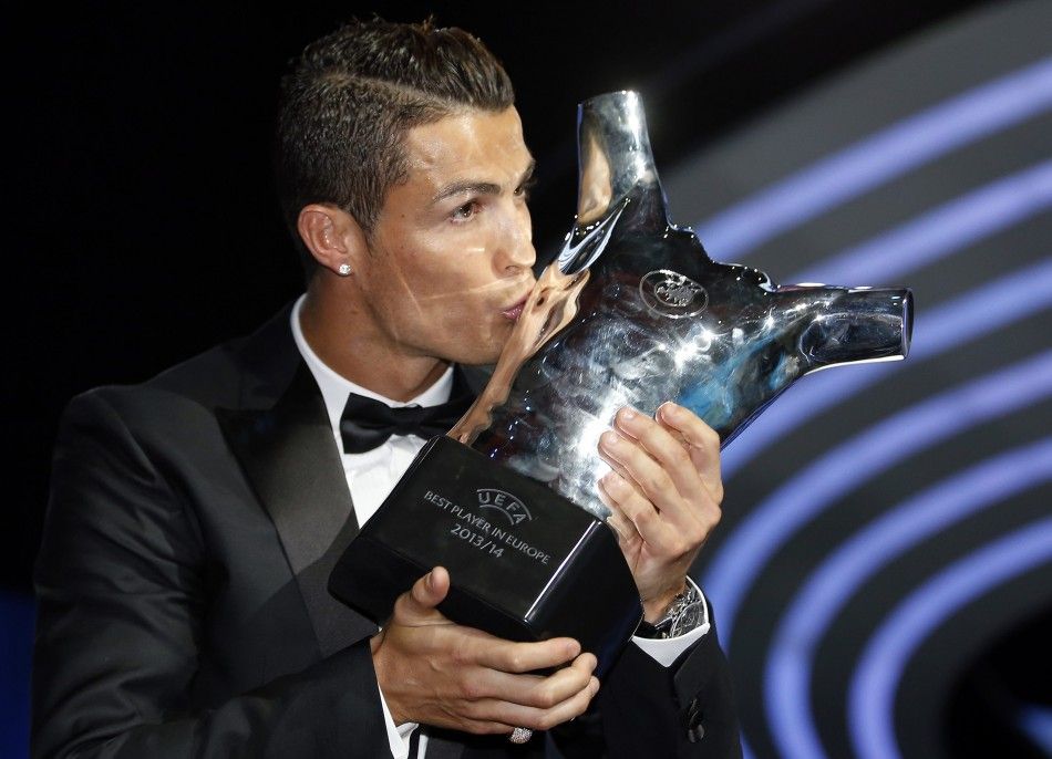 Real Madrids Cristiano Ronaldo kisses his Best Player UEFA 2014 Award during the draw ceremony for the 20142015 Champions League Cup soccer competition at Monacos Grimaldi Forum in Monte Carlo August 28, 2014. 