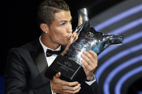 Real Madrid's Cristiano Ronaldo kisses his Best Player UEFA 2014 Award during the draw ceremony for the 2014/2015 Champions League Cup soccer competition at Monaco's Grimaldi Forum in Monte Carlo August 28, 2014. 